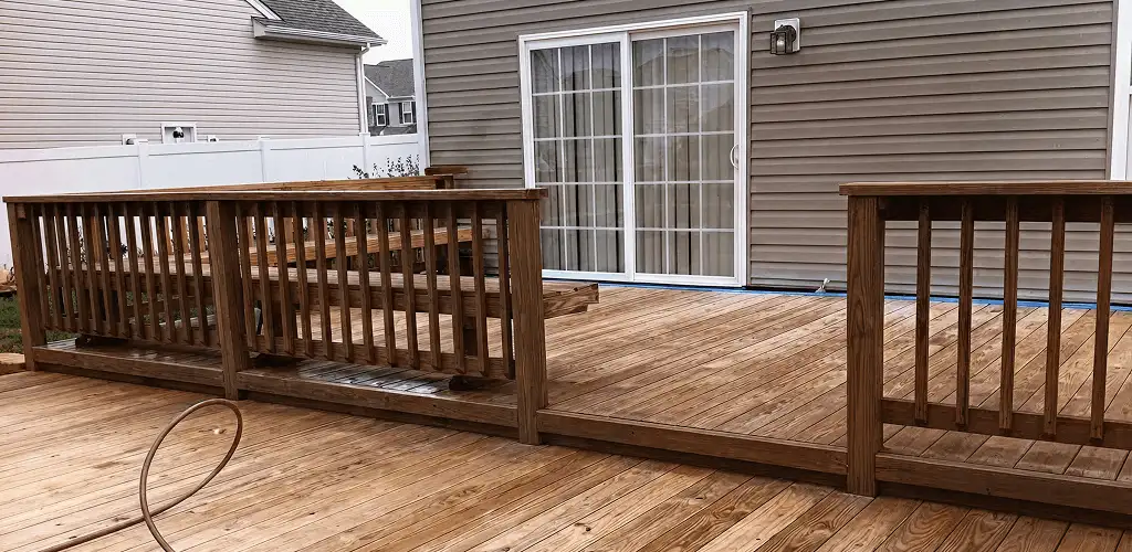 Deck sealing service protecting a backyard wood deck and railings in Bellevue, WA