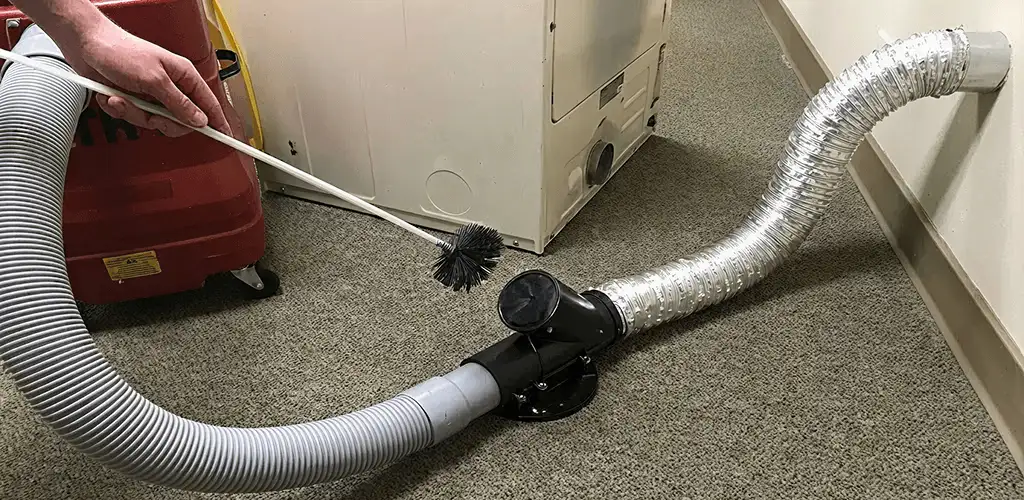 Dryer vent cleaning service removing lint from a dryer duct connection in Bellevue, WA