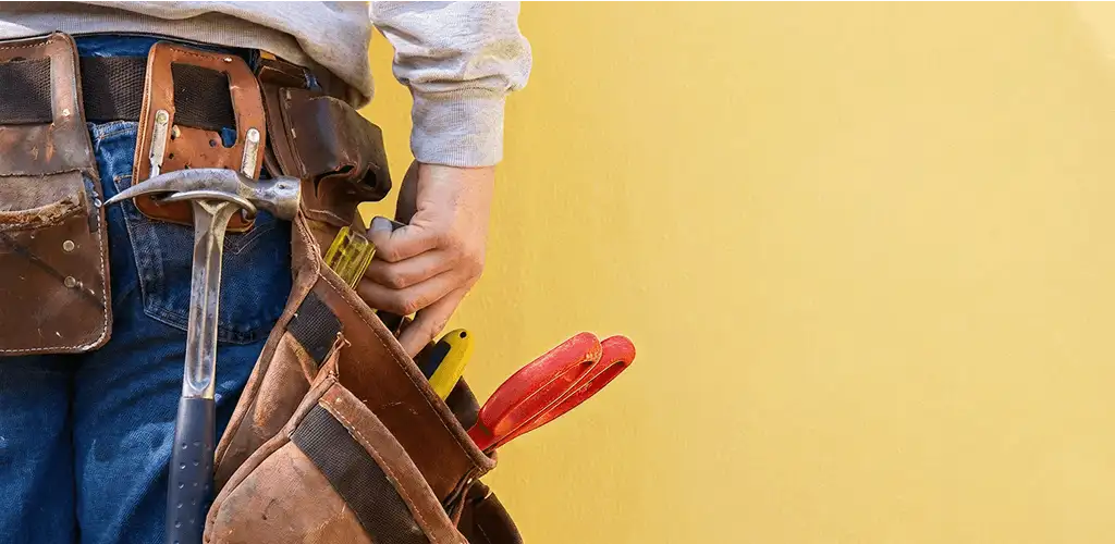Handyman with tool belt ready for home repairs and maintenance in Bellevue, WA