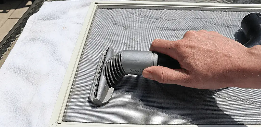 Window screen repair cleaning and fixing a damaged screen mesh in Bellevue, WA