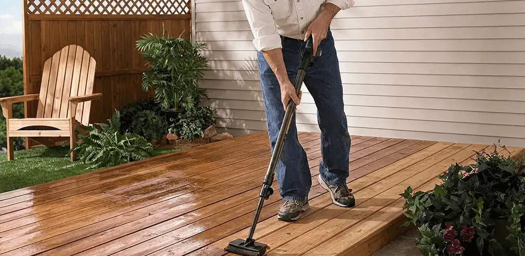 Deck staining service applying stain to a backyard wood deck in Bellevue, WA